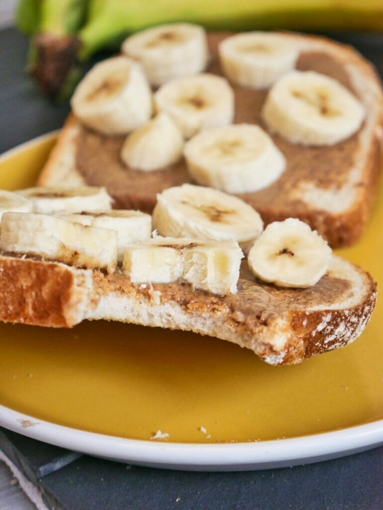 almond butter and banana toast with a bite taken out of it