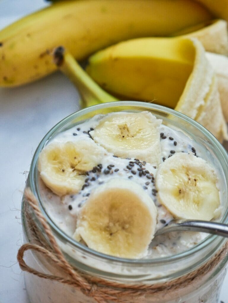 banana overnight oats with spoon and chia seeds
