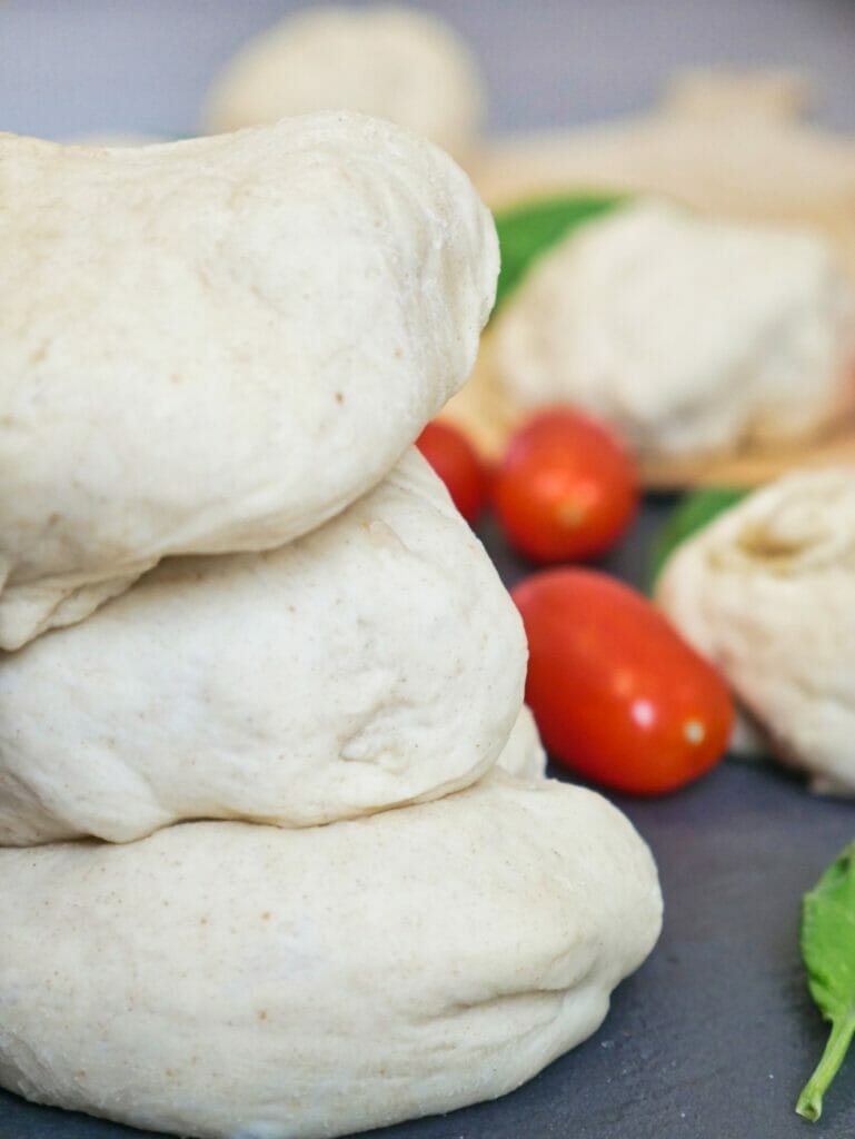 stacked balls of uncooked pizza dough