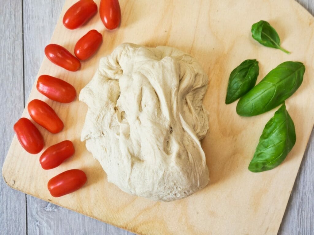 ball of pizza dough on pizza board from above