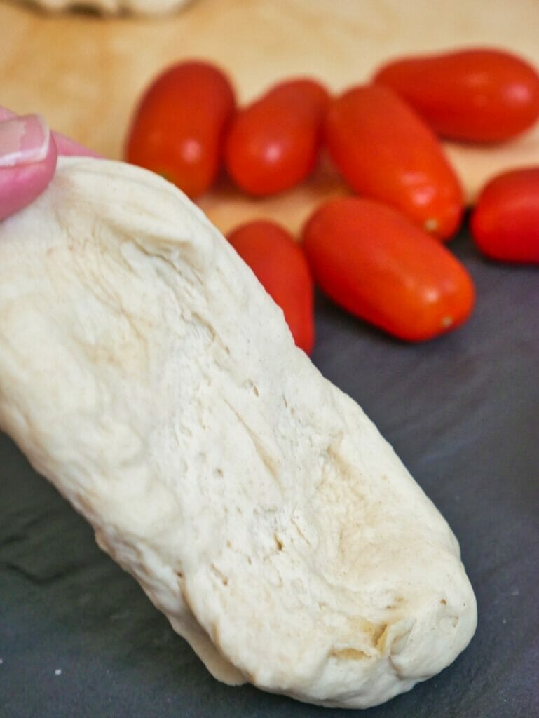 stretched out ball of pizza dough