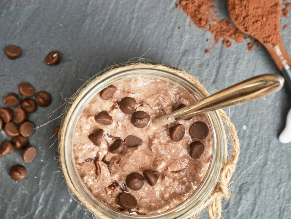 cocoa overnight oats in mason jar with spoon