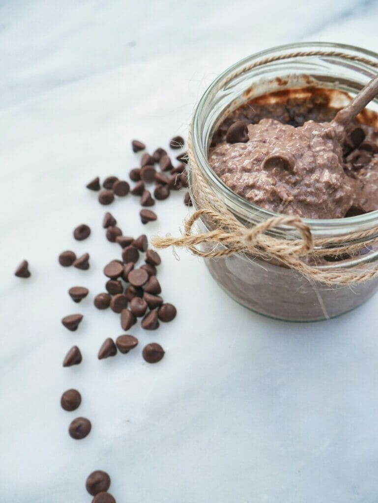 cocoa overnight oats with spoon and chocolate chips