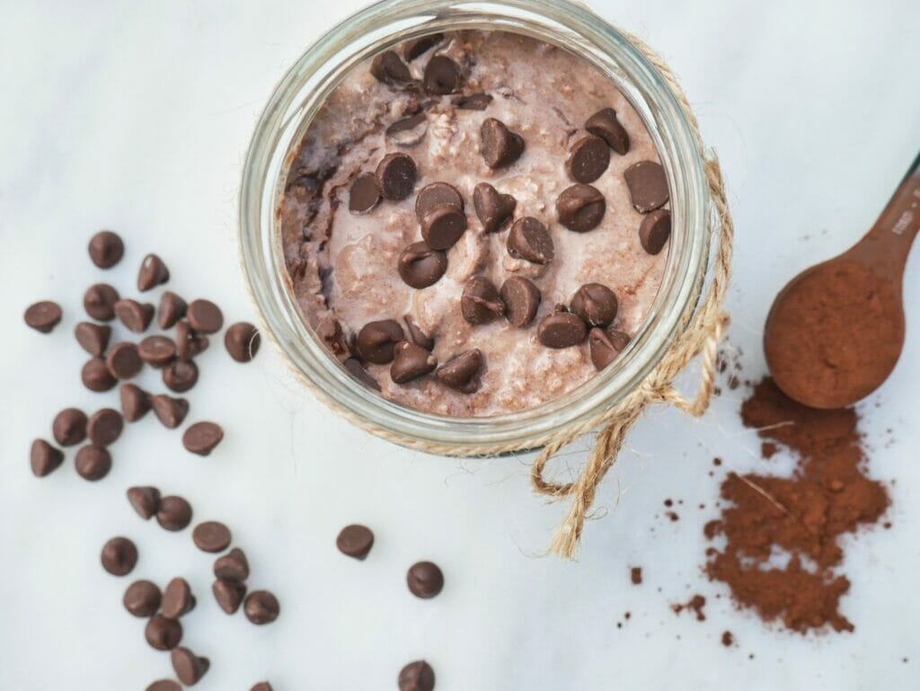 cocoa overnight oats with chocolate chips and spoon of cocoa