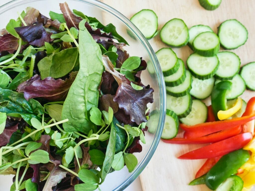 bowl of salad with chopped cucumbers and bell peppers