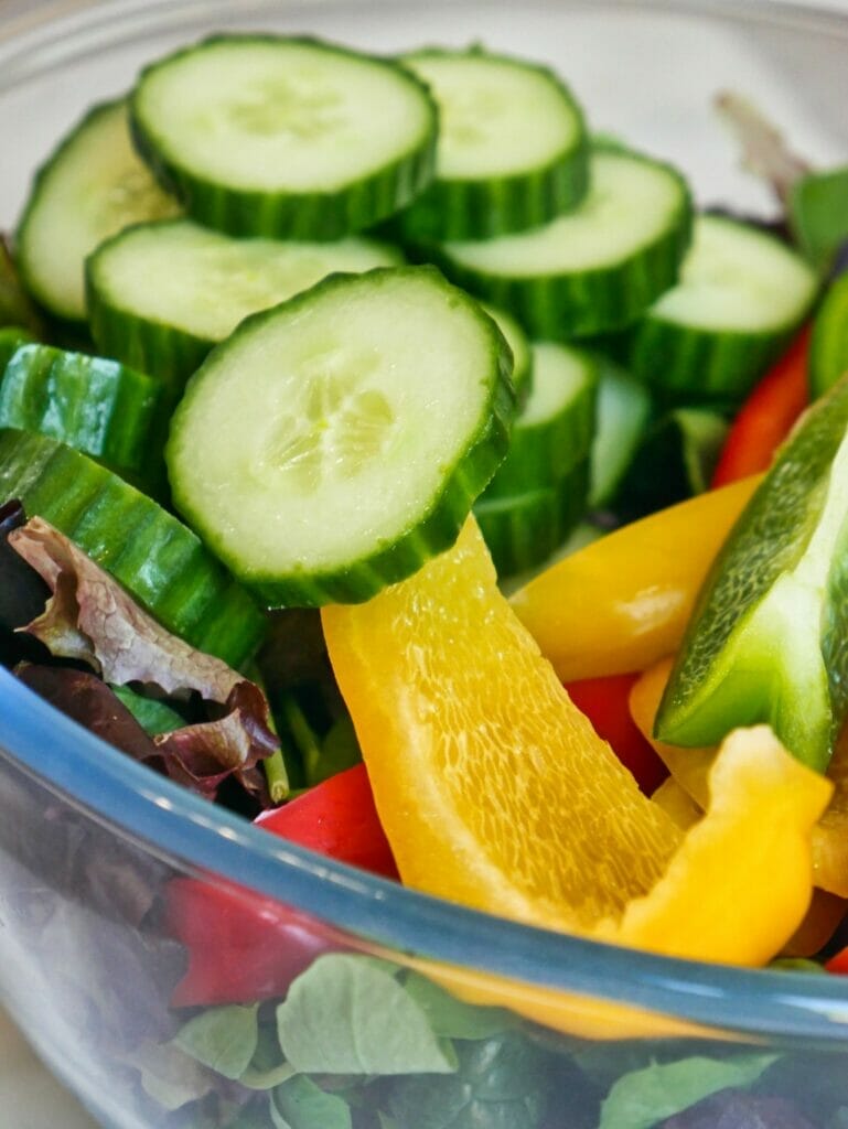 cucumbers and bell peppers in a bowl