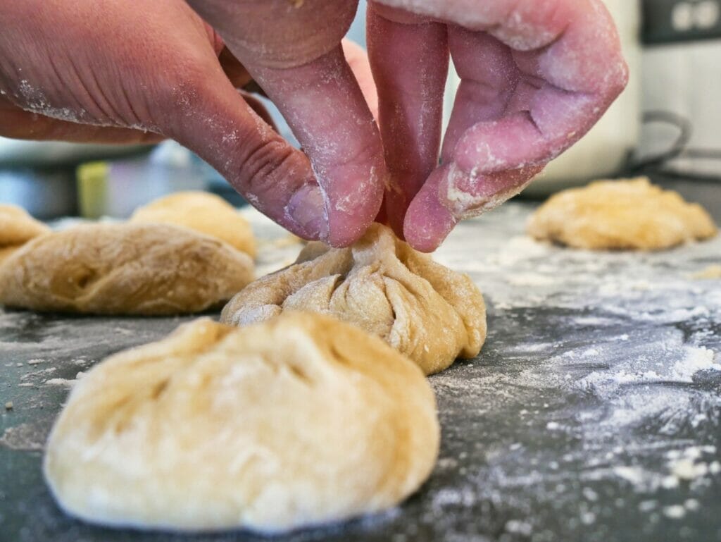 pinching together brioche buns