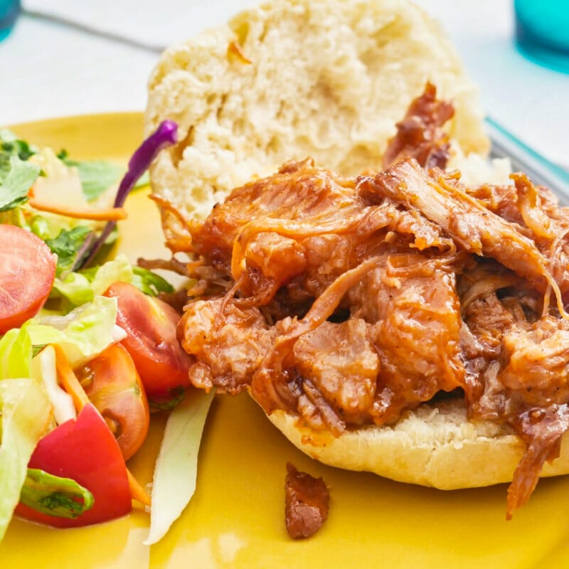 Homemade BBQ pulled pork in a brioche bun with salad entree recipe