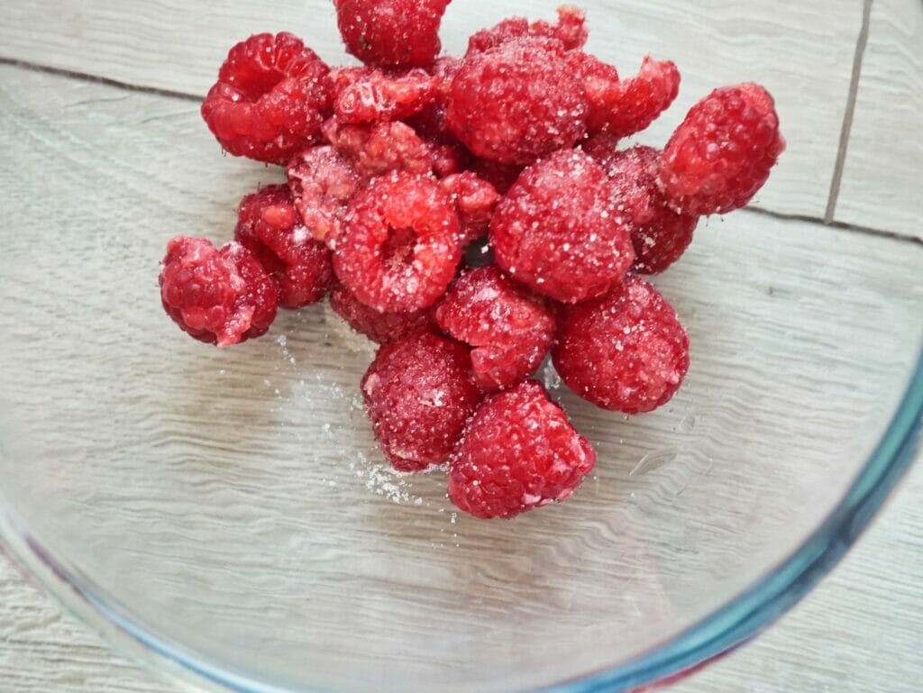 raspberries in bowl with sugar