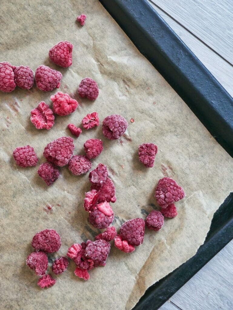 frozen raspberries on parchment paper