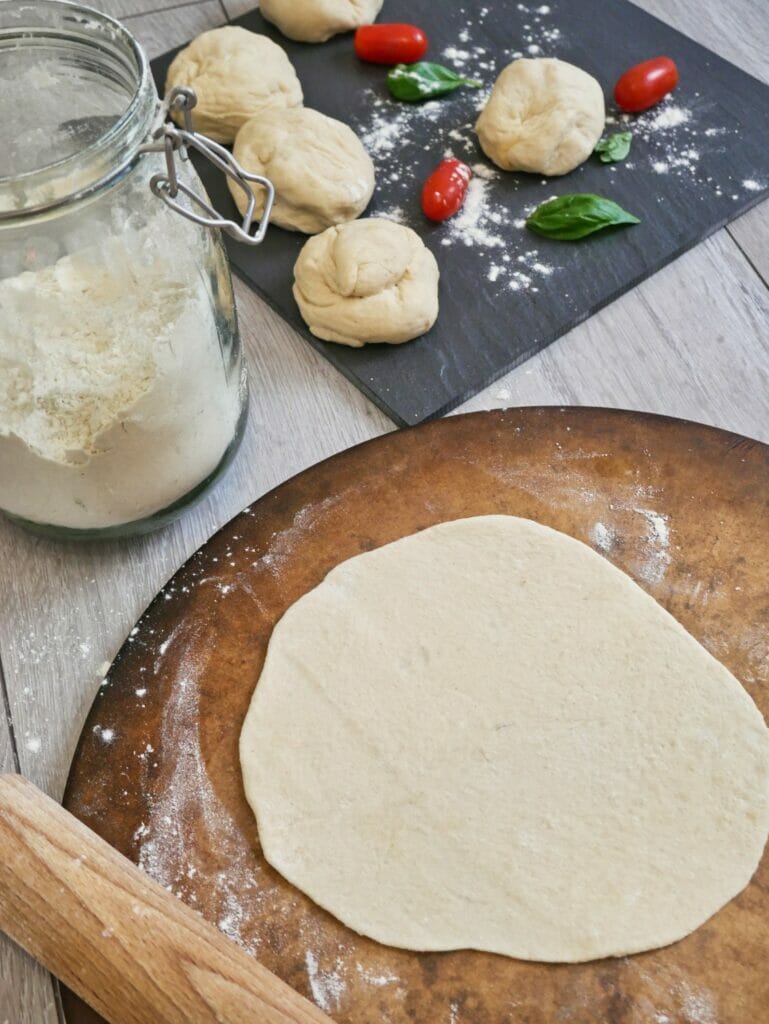 rolled out pizza crust on pizza stone