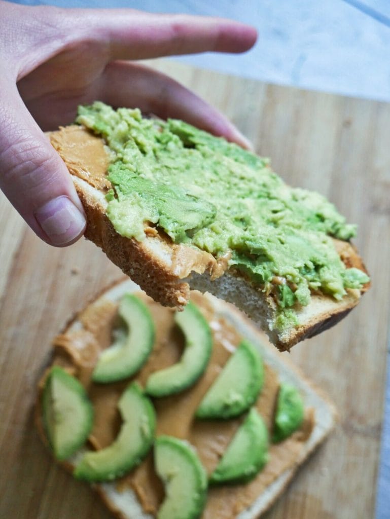 bite out of avocado peanut butter toast