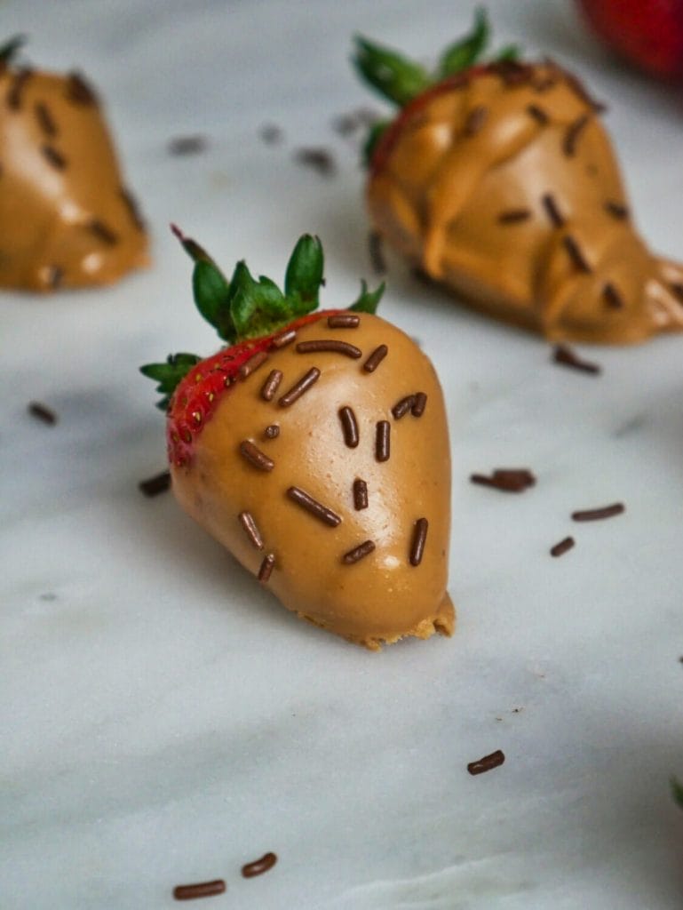 strawberry covered in peanut butter and sprinkles