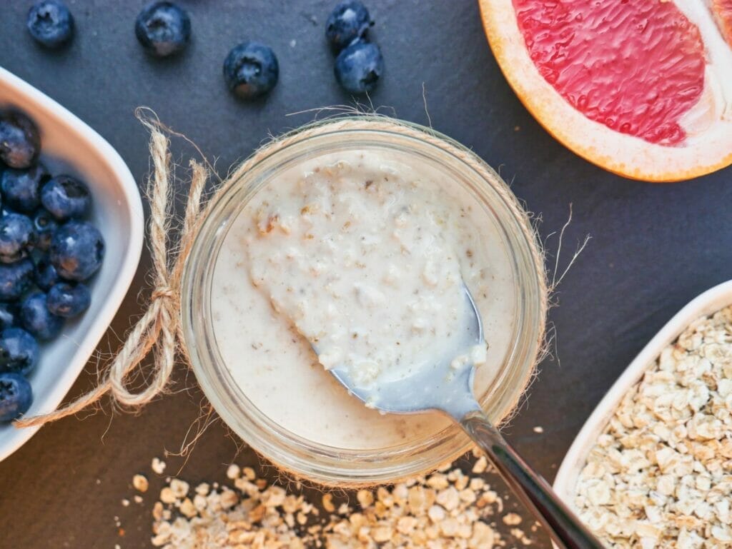 spoon with overnight oats in mason jar