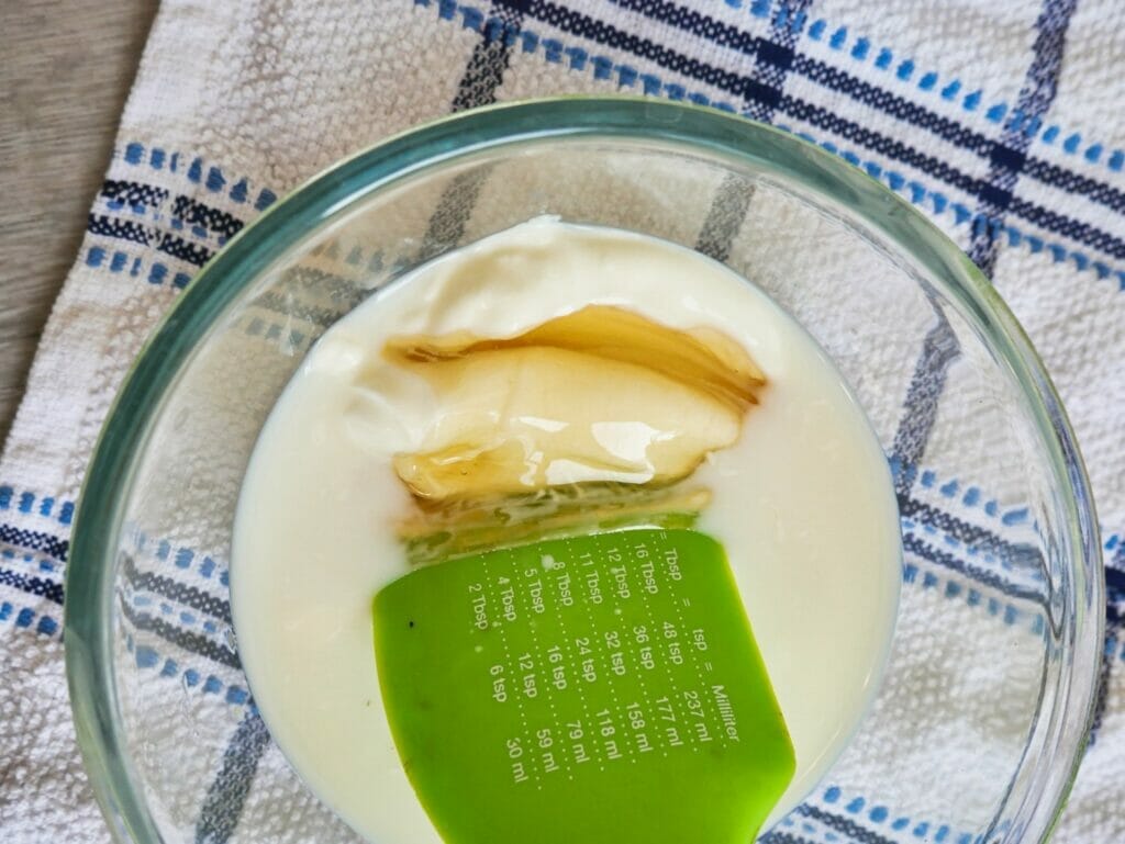 mixing honey and yogurt in a bowl