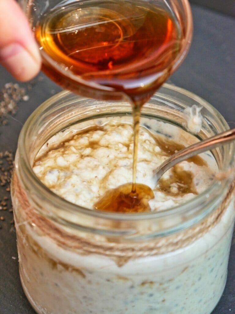 pouring vanilla into overnight oats