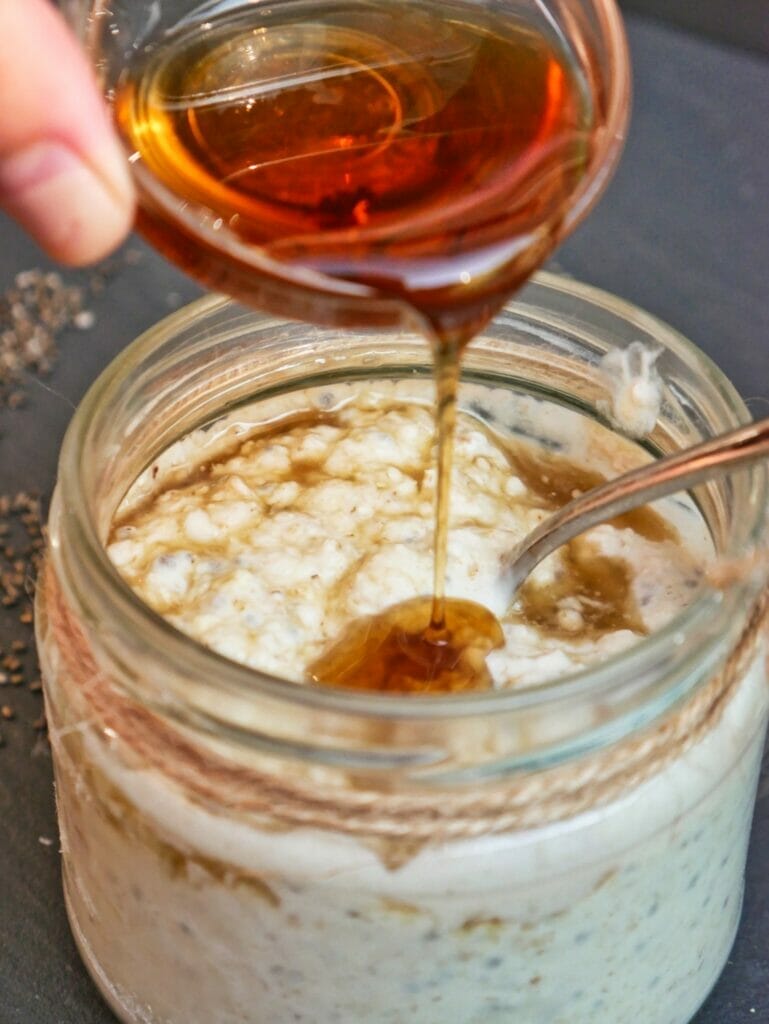 pouring vanilla into overnight oats