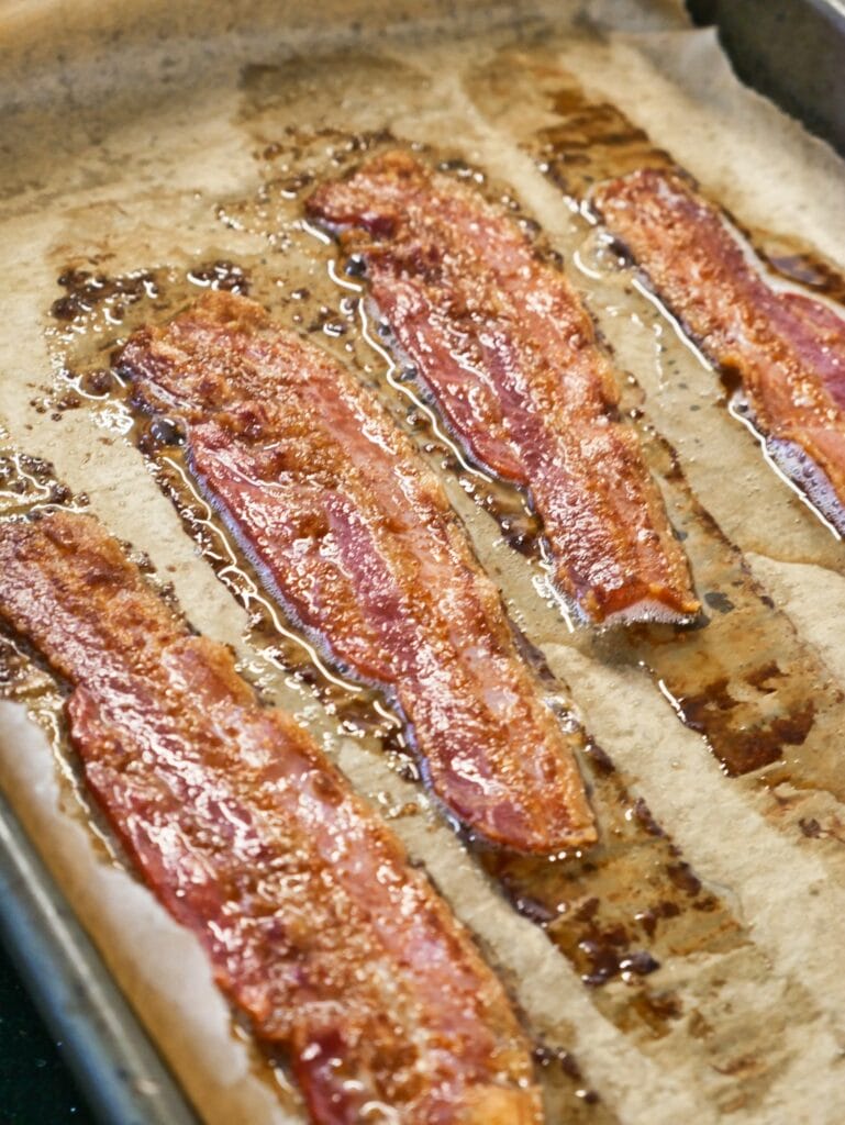 cooked bacon on parchment paper