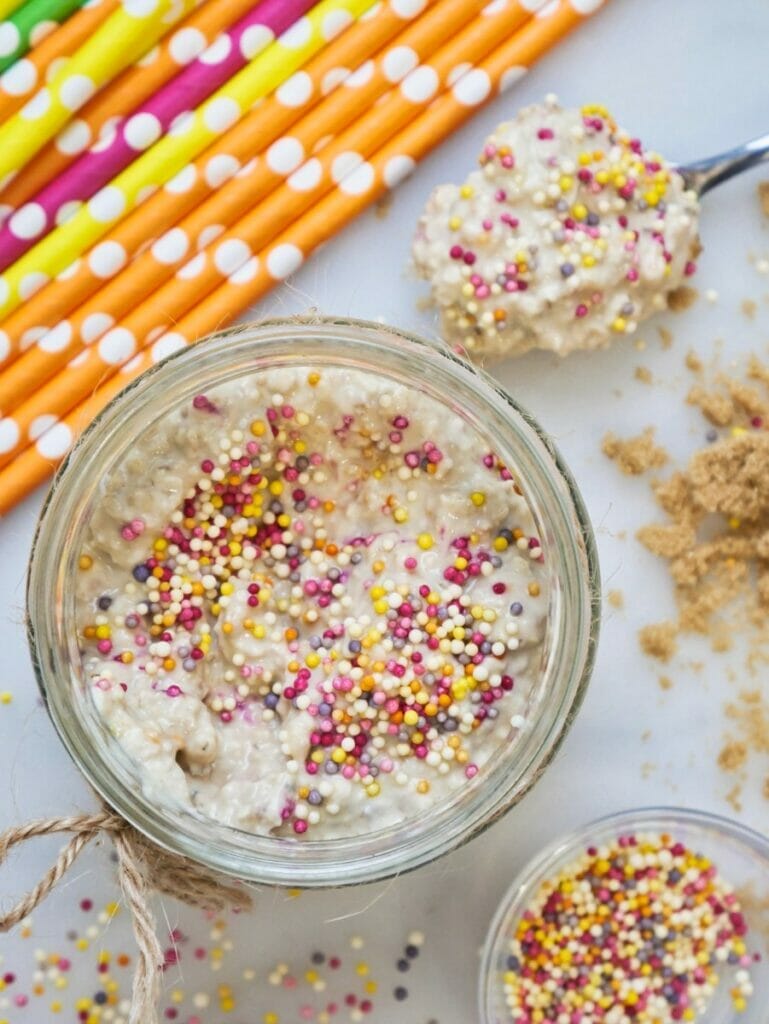 birthday cake overnight oats with colorful straws