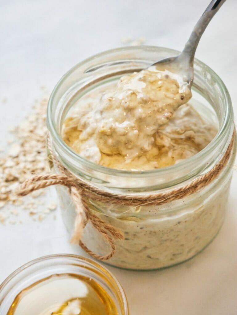 honey overnight oats in a jar with a spoon