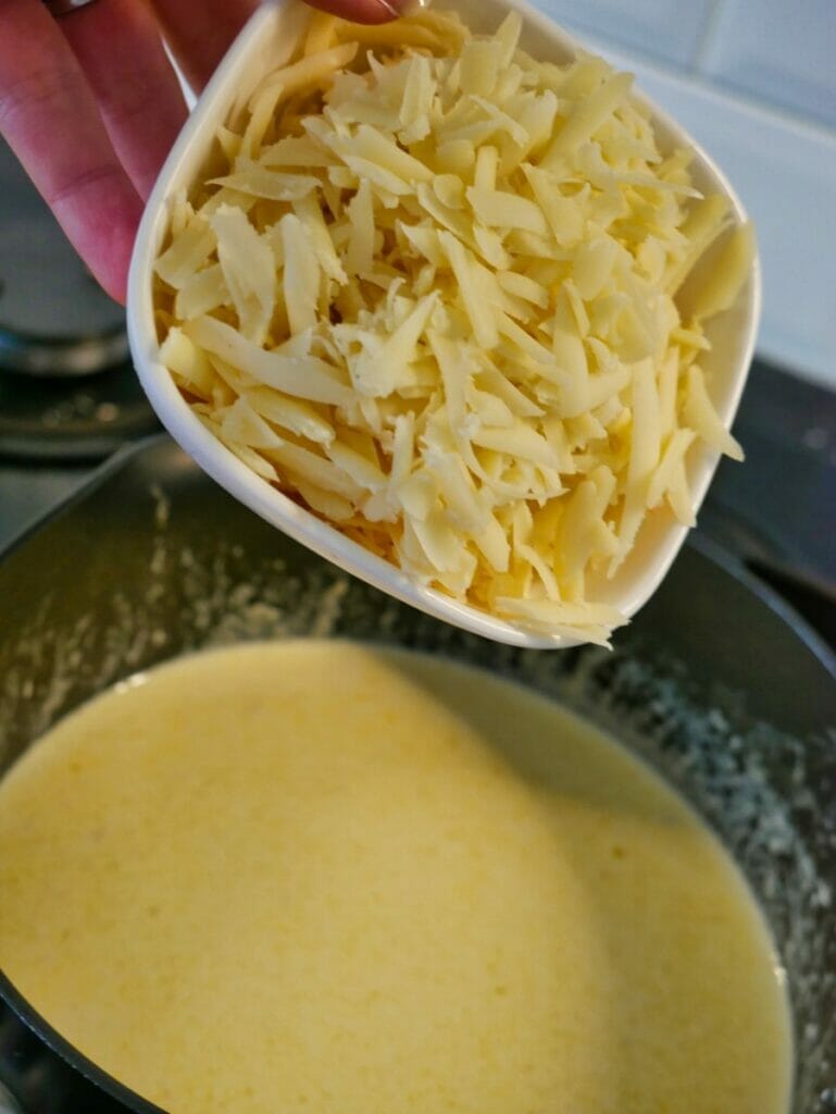 pouring cheese into pot