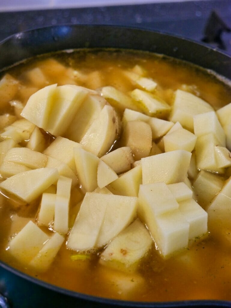 potatoes in pot with broth