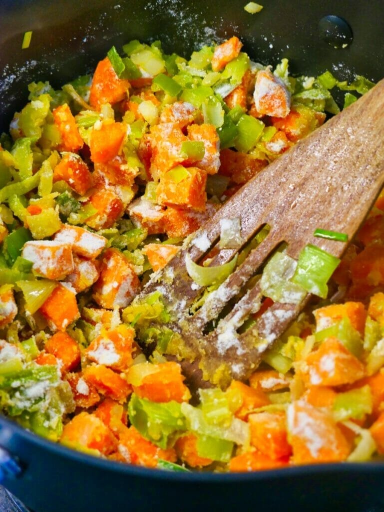carrot and vegetables in pot with flour