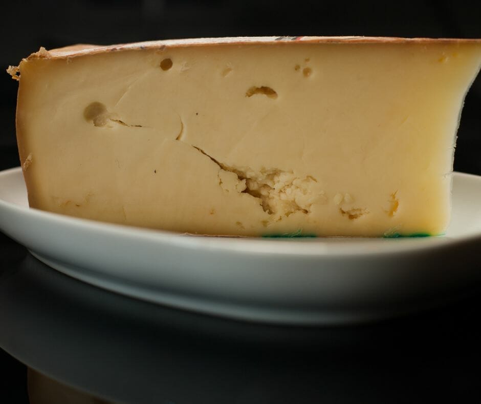 Close up of a wedge of Fontina cheese