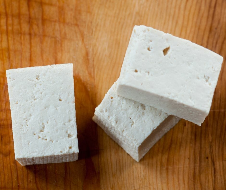 Extra firm tofu on a wooden table 