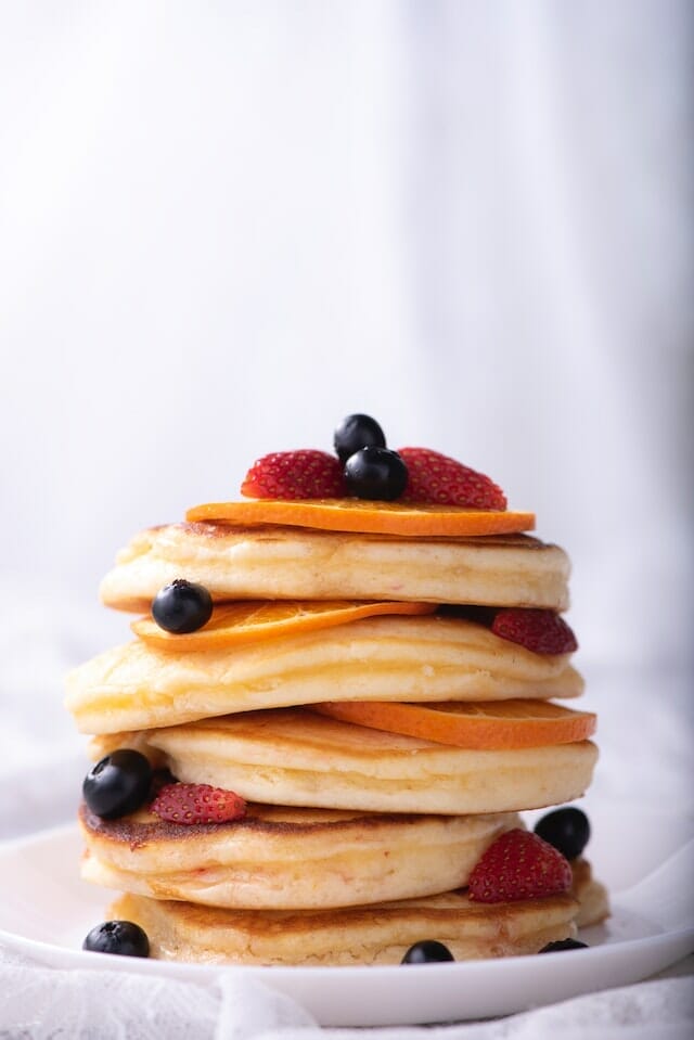 Stack of pancakes with strawberries and blueberries 